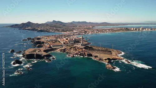 Drone flight over Cabo de Palos and La Manga in Murcia, Spain. Panoramic view of the Mediterranean coast. Sea and blue sky on a sunny day.
