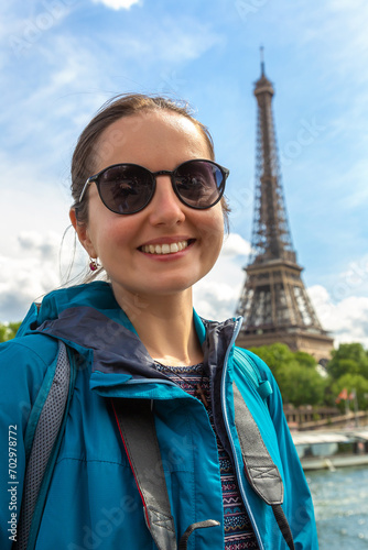 Woman traveler at Eiffel Tower in Paris, France
