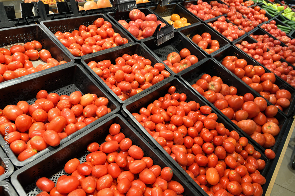 Shop window with tomatoes in plastic boxes