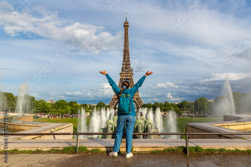Woman traveler at Eiffel Tower and fountains of Trocadero in Paris, France