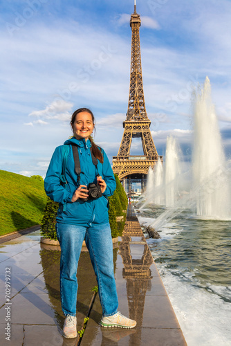Woman traveler at Eiffel Tower and fountains of Trocadero in Paris, France