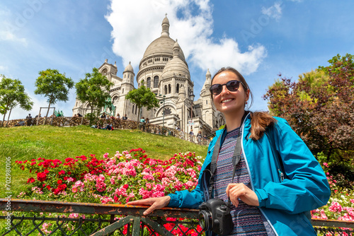 Woman traveler at Basilica of the Sacred Heart at Montmartre hill in Paris, France