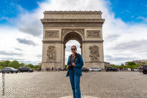 Woman traveler at Paris Arc de Triomphe (Triumphal Arch) in Paris, France