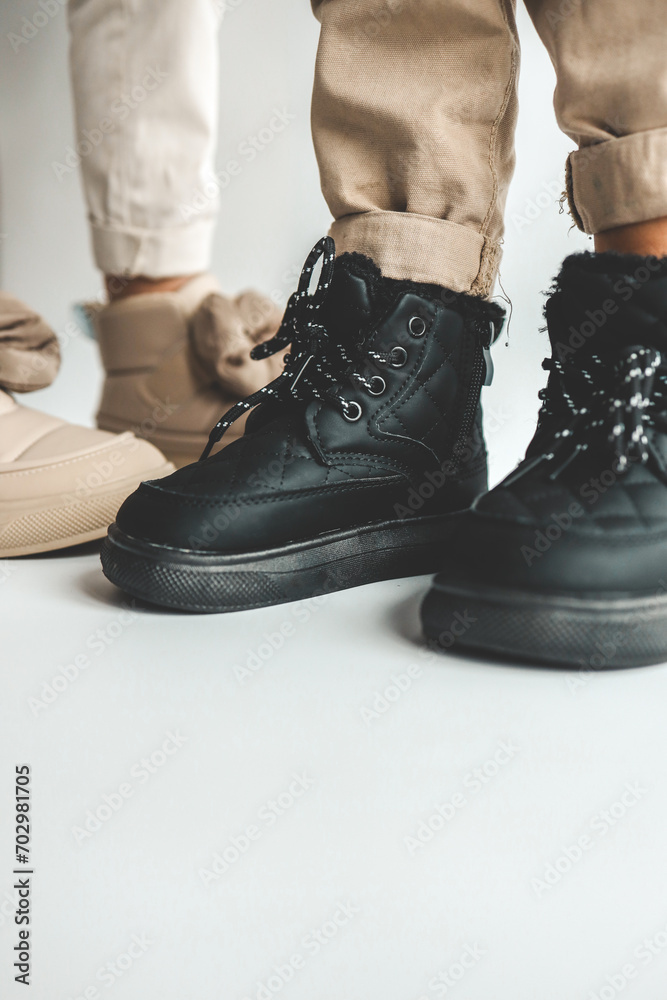 Stylish fashionable boots close-up for boys and girls Stylish fashionable boots close-up for boys and girls