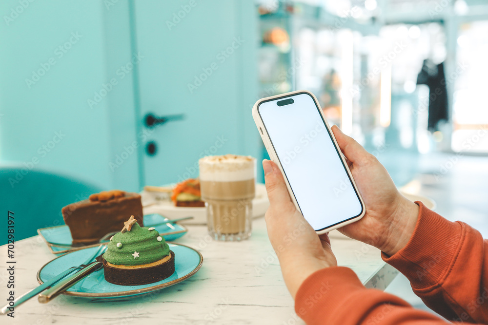 Phone with isolated screen on background of food in restaurant - obrazy, fototapety, plakaty 