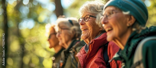Elderly people in Boston find happiness and motivation in a diverse exercise group trekking outdoors, embracing an active and fun lifestyle with friends. photo