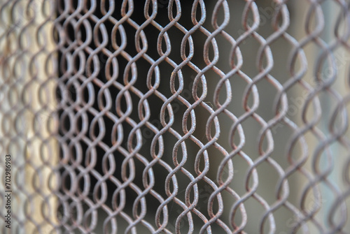 metal grid background. metal mesh for fencing, close up view. blur in the photo.