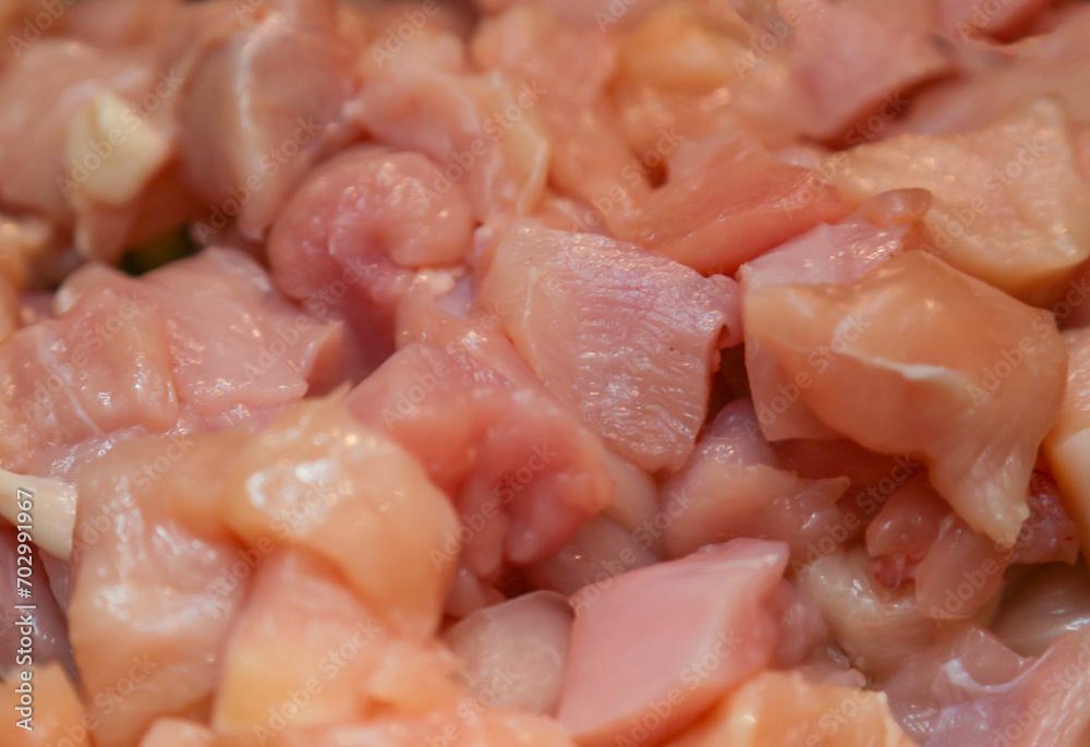 Chopped raw chicken fillet for background use. A slide of sliced raw boneless chicken breasts in close-up, background, texture. Chopped raw chicken fillet for background use. A slide of sliced raw boneless chicken breasts in close-up, background, texture.