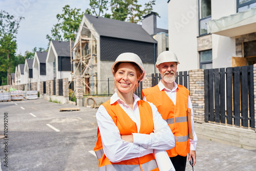 Construction supervisor and her colleague inspecting new housing complex