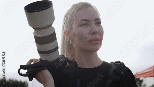 Photographer with camera at work outdoors