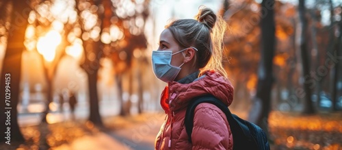girl wears mask while doing outdoor sports amid COVID-19 photo
