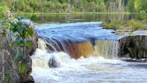 Voytsky padun waterfall in autumn. The famous powerful and wide Karelian waterfall Voytsky Padun is surrounded by rocks and greenery. Cascading waterfall on the river. Karelia, Russia 4K photo