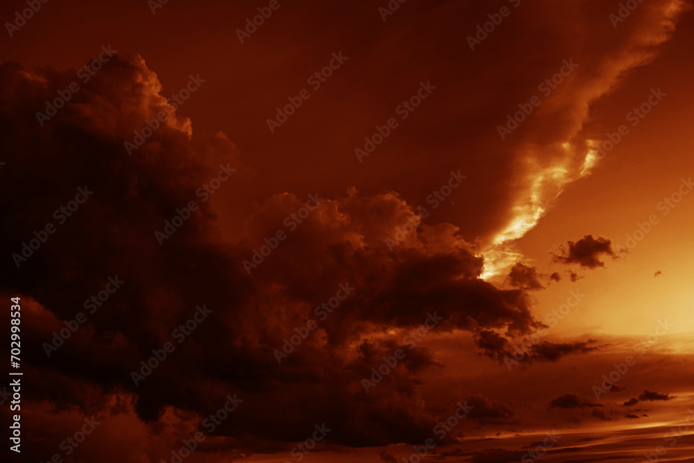 Fototapeta premium Red orange gold yellow cloudy sky. Black dark storm ominous clouds. Night evening sunset sun light. Dramatic background. Rain wind thunderstorm lightning. Epic. Or fire smoke creepy horror concept.