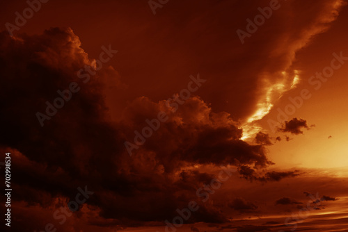 Red orange gold yellow cloudy sky. Black dark storm ominous clouds. Night evening sunset sun light. Dramatic background. Rain wind thunderstorm lightning. Epic. Or fire smoke creepy horror concept.