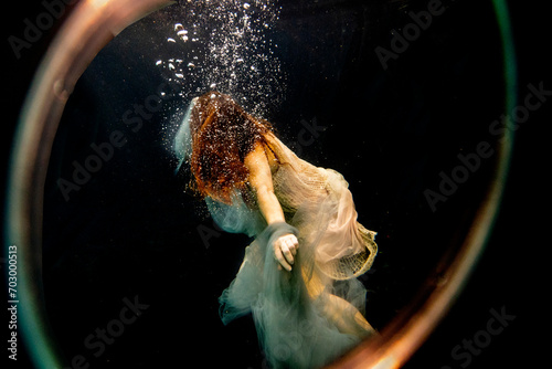 Looking through lens at an underwater swimmer