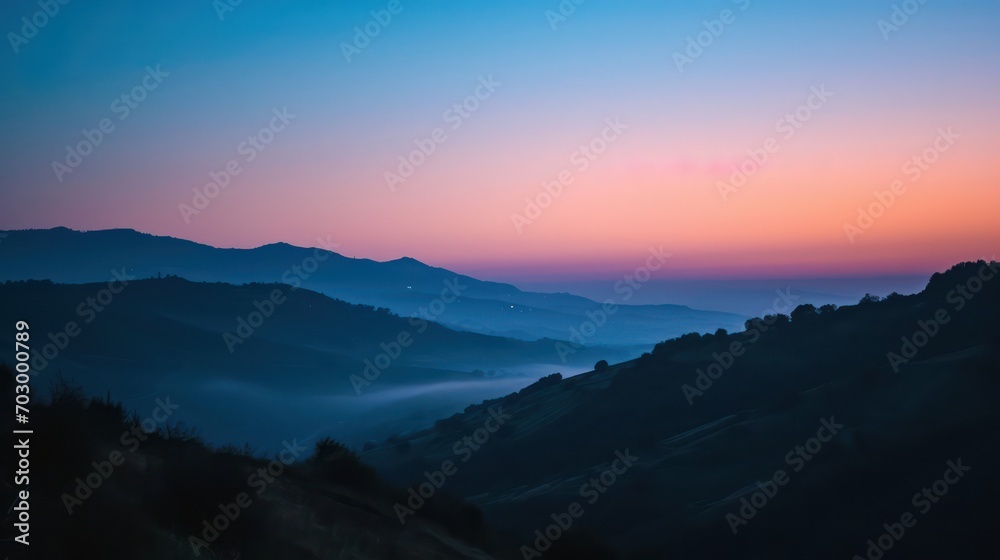A breathtaking view of the sunrise during the blue hour, creating a serene atmosphere with the sky painted in hues of blue and purple.
