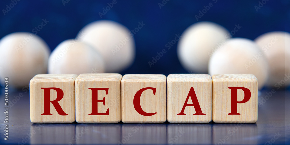 RECAP - word on wooden cubes on a blue background with wooden balls RECAP - word on wooden cubes on a blue background with wooden balls