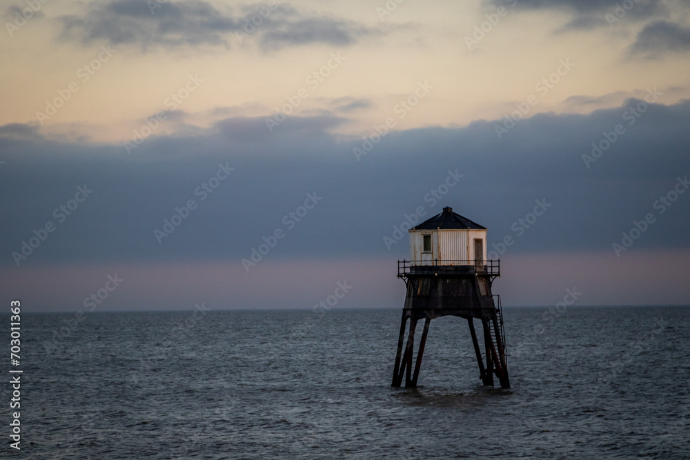 Lighthouse in the sea at sunset, Dovercourt low lighthouse at high tide built in 1863 and discontinued in 1917 and restored in 1980 the 8 meter lighthouse is still a iconic sight