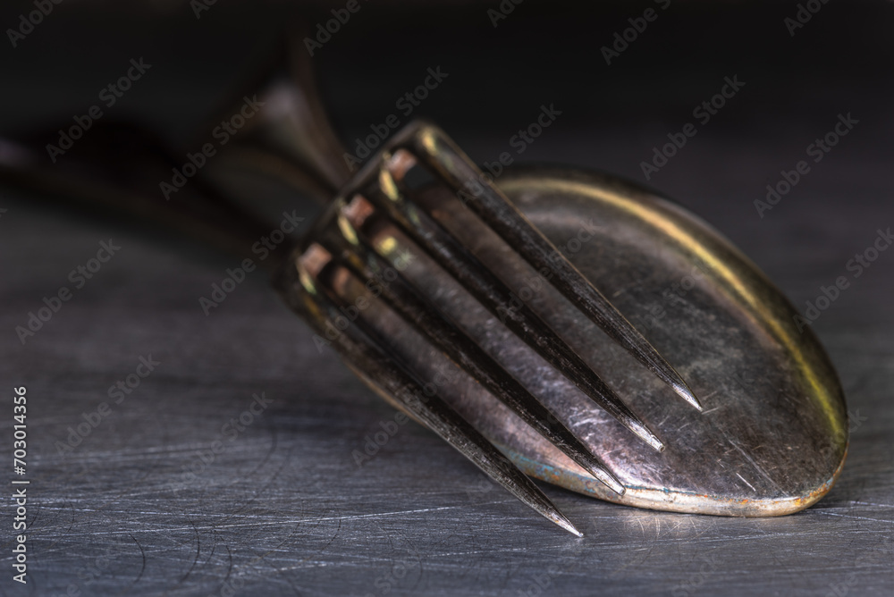 Fork and Spoon Old Silverware on Metal Table Surface Close-up View