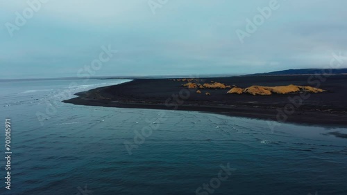 Drone flying by the coastline of Blacksand beach photo