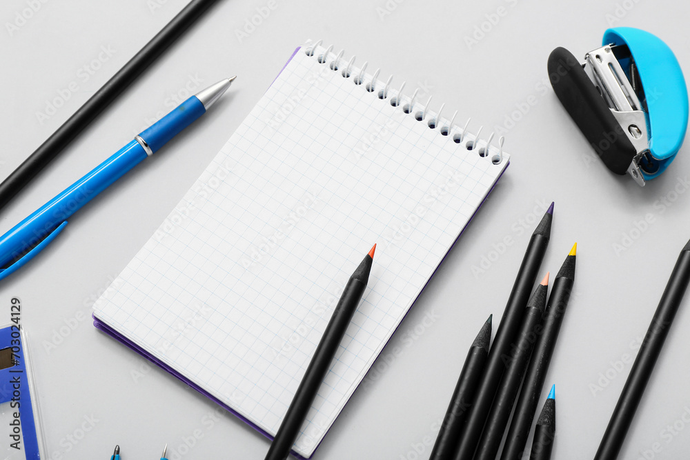 Many colorful pencils with stationery on grey background Many colorful pencils with stationery on grey background