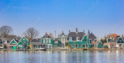 Wooden houses at the Zaan river in Zaandijk, Netherlands photo