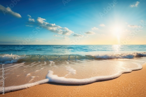 Sunny beach with gentle waves under a clear blue sky