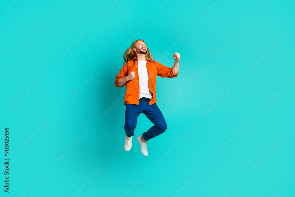 Full size photo of ecstatic guy dressed blue jeans flying look empty space win lottery scream yeah isolated on turquoise color background
