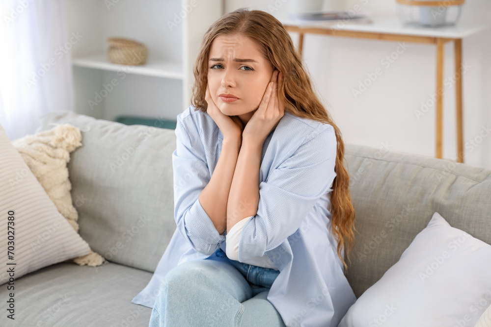 Young woman suffering from loud neighbours at home Young woman suffering from loud neighbours at home