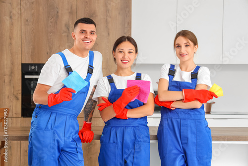 Team of young janitors with rags in kitchen © Pixel-Shot