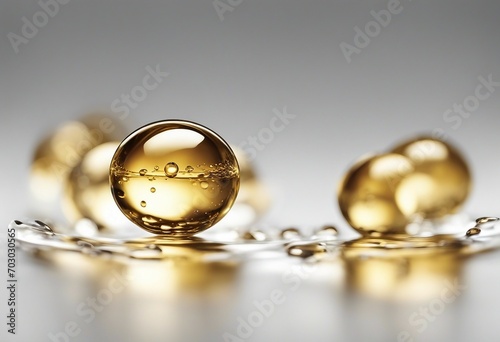 Golden oil droplet isolated on grey background
