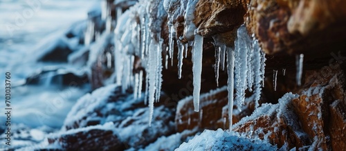 December ice icicles on the sandstone cliff wall at Vidzeme rocky seashore in Latvia. photo