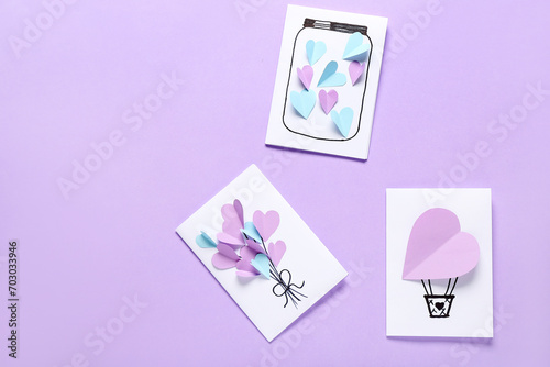 Beautiful greeting cards for Valentine's Day celebration on lilac background