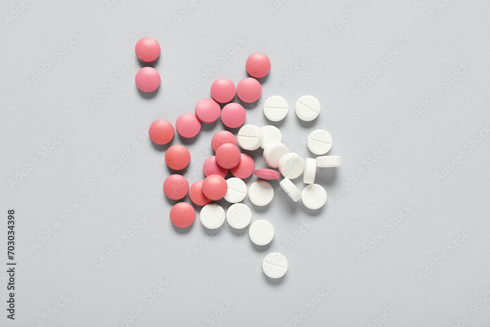 Pile of pills on grey background