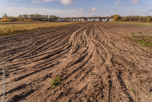 Tractor tracks on the soil of an agricultural field in autumn.
