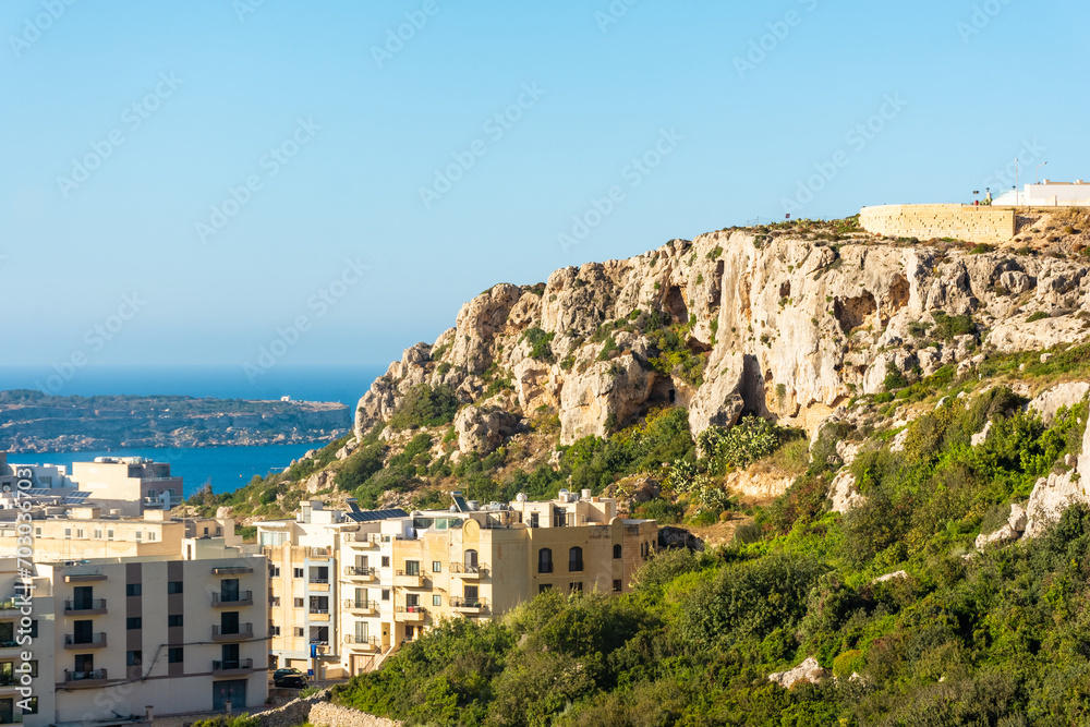 Houses built under a cliff in Mellieha,  Malta