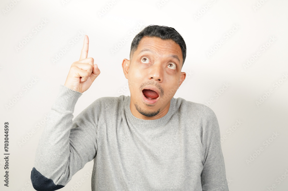Fototapeta premium surprised, shocked expression of Asian Man with hand point, isolated background