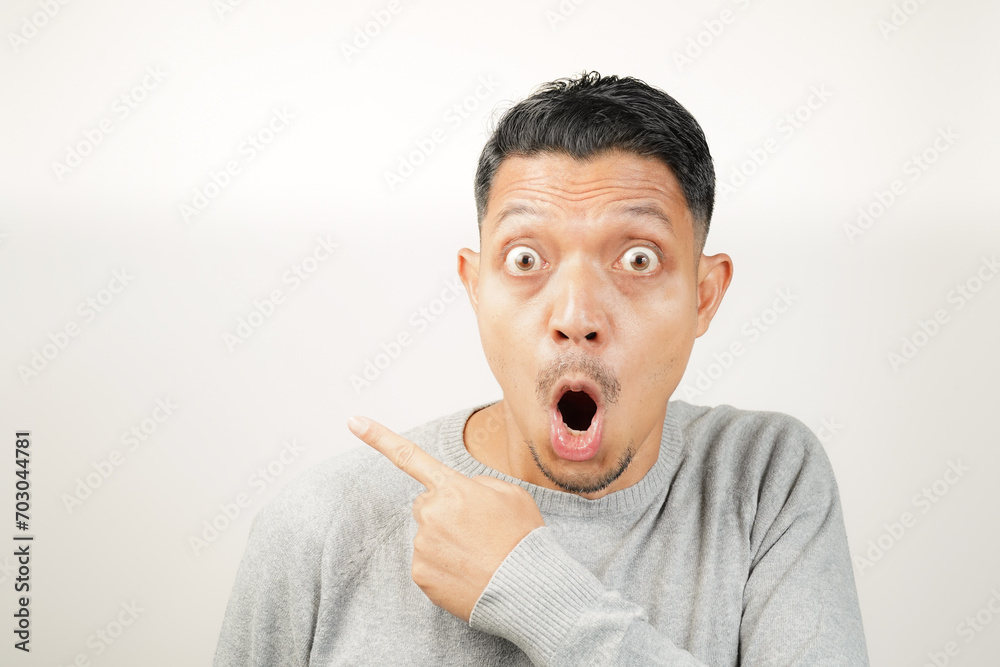 surprised, shocked expression of Asian Man with hand point, isolated background surprised, shocked expression of Asian Man with hand point, isolated background