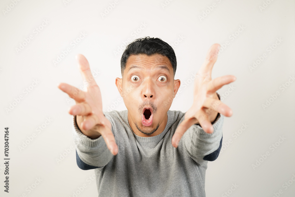 surprised, shocked expression of Asian Man with both fingers open, isolated background surprised, shocked expression of Asian Man with both fingers open, isolated background