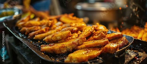Popular street food in Southeast Asia, especially in Indonesia, Malaysia, and Singapore, is fried banana, known as pisang goreng. photo