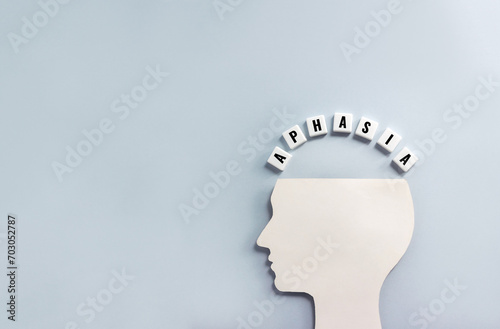 Silhouette of human head and word Aphasia made from plastic blocks with letters. Disease concept, copy space