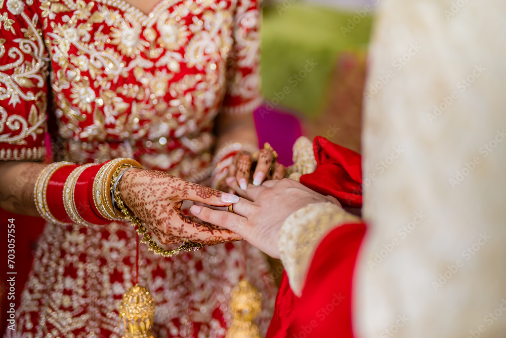 Indian couple's exchanging wedding rings hands close up