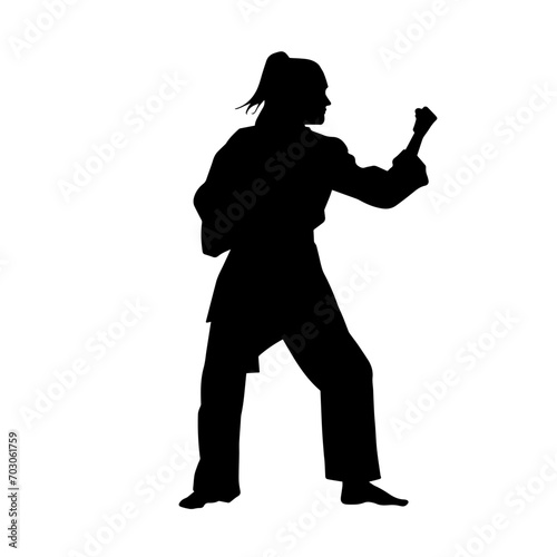 Silhouette of a slim female doing martial art pose. Silhouette of a martial art woman in action pose.