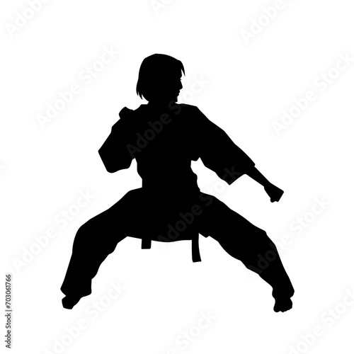 Silhouette of a slim female doing martial art pose. Silhouette of a martial art woman in action pose.