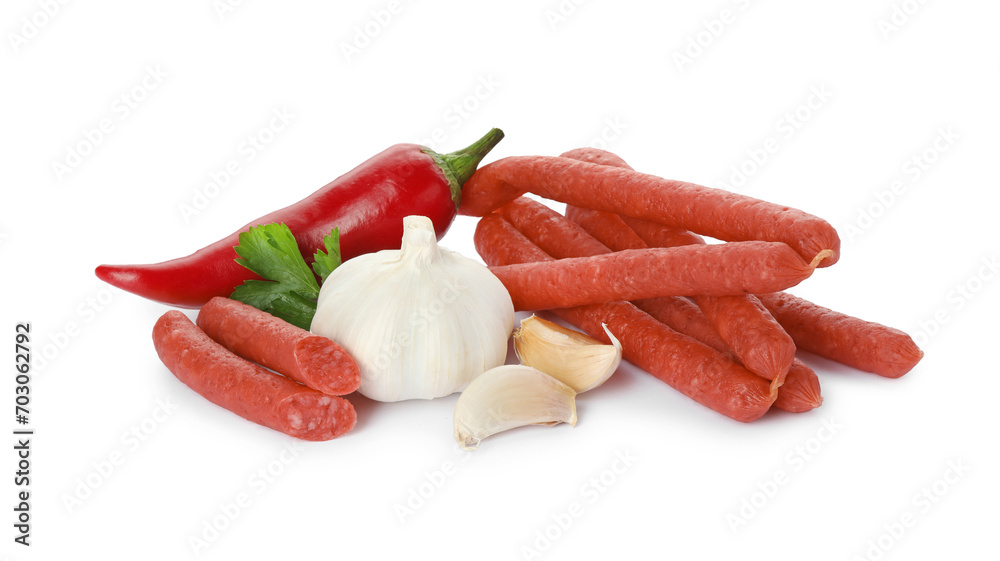 Thin dry smoked sausages and different spices isolated on white Thin dry smoked sausages and different spices isolated on white