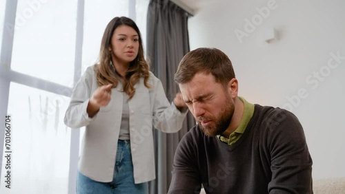 Annoyed nervous wife shouting screaming on frustrated husband accusing in cheat threatening with breakup divorce photo