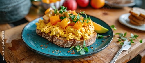 Delicious vegan breakfast: Scrambled egg sandwich with fruit salad. Scandinavian fresh style, homemade.