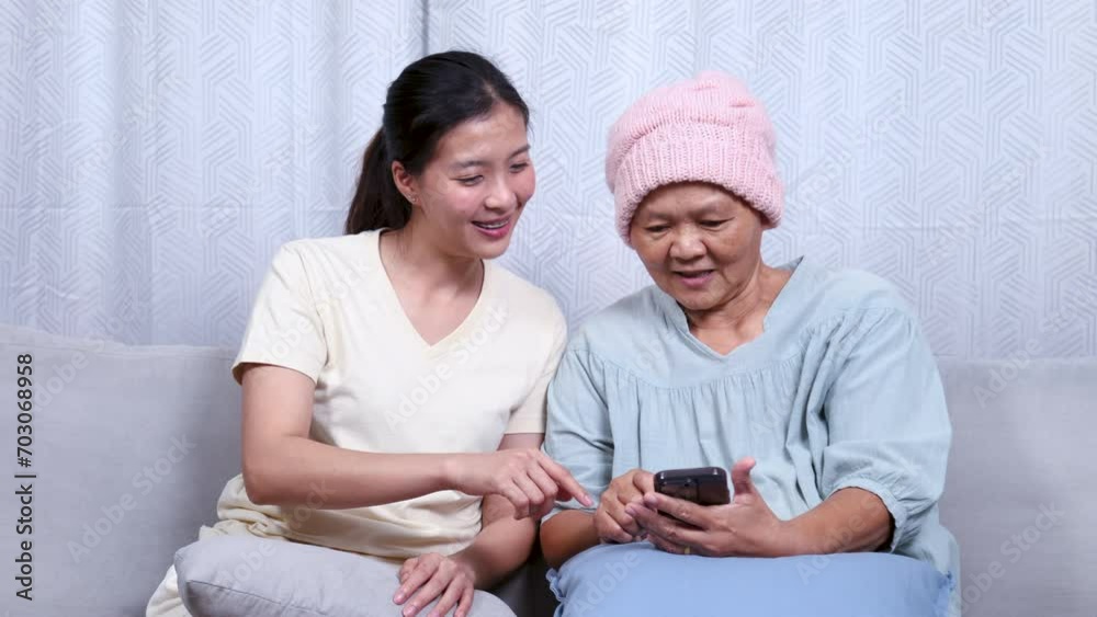 Asian caregiver nurse female receive call from hospital with good news for elderly patient woman end session of chemotherapy Asian caregiver nurse female receive call from hospital with good news for elderly patient woman end session of chemotherapy