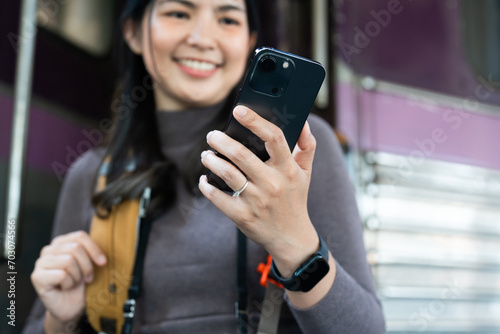 Woman using mobile phone for looking at map while travel by train. travel concept