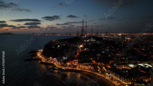 Aerial view circling radio towers on the coast of Mazatlan, colorful dusk in Mexico photo